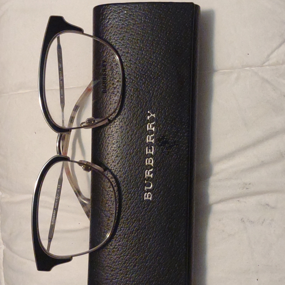 Burberry 1334 Eyeglasses black and gold with plaid trademark around ear piece.